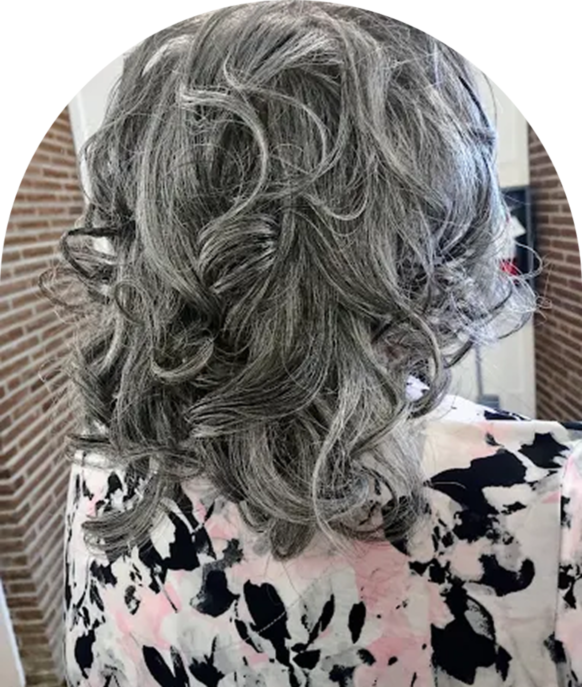 Curly gray hair with floral blouse.